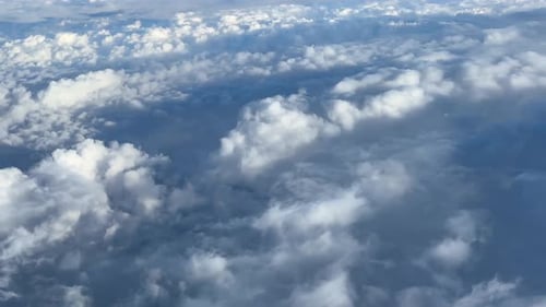 Flight Over Clouds With Blue Sky And Jet Engine View