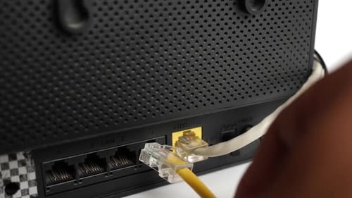 Ethernet Cable Being Plugged Into a Router