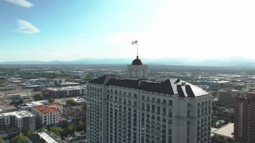 American Flag Waving Atop City Building Aerial View