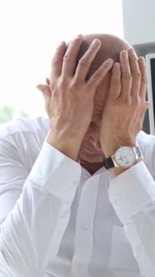 Worried Man Gesturing in Workplace