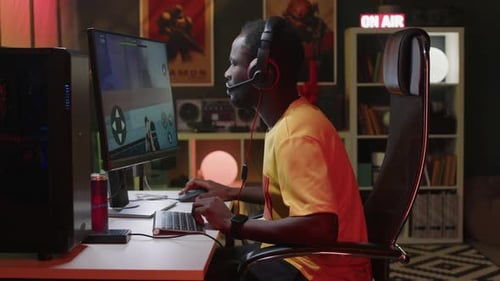Young Man Playing Video Game at Computer