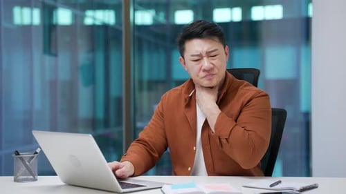 Man Working at Desk with a Sore Throat