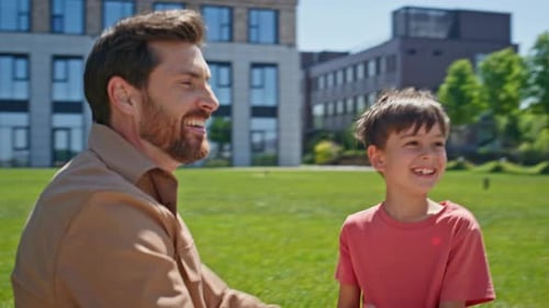 Dad and Son Laughing, Playing Hand Game