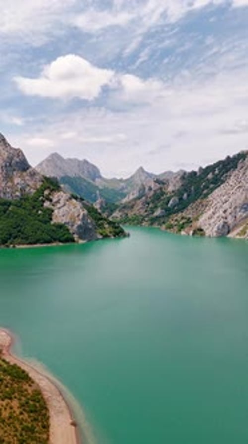Peaceful surface of picturesque lake at the foot of the mountains.