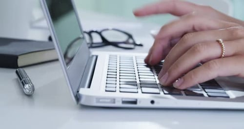 4k video footage of an unrecognisable businesswoman typing on a laptop in an office