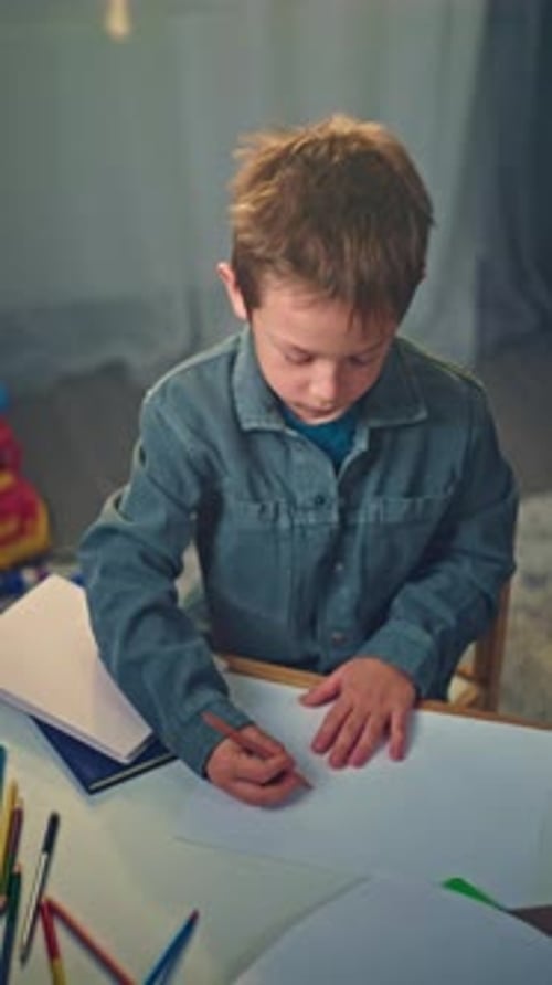 Creative Child Drawing at Home Boy Using Pencils to Express Imagination