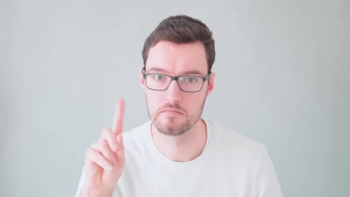 Man with Glasses Saying No and Raising Finger