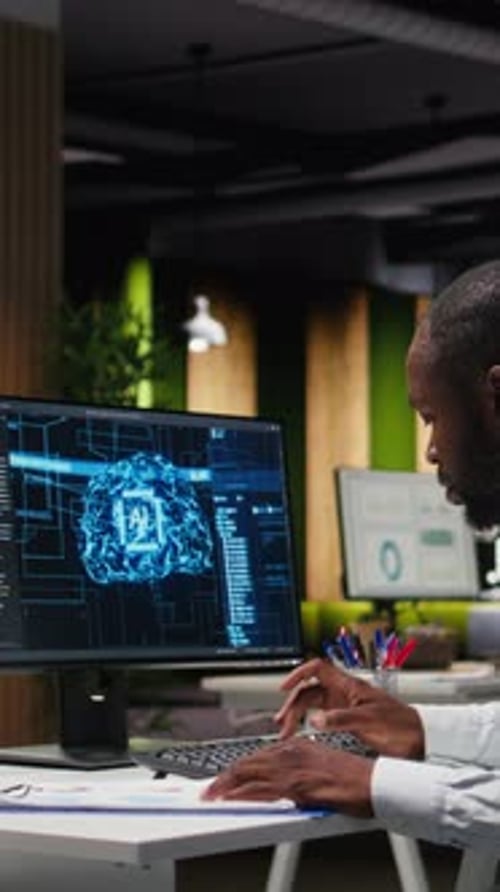 Man works with AI at office computer