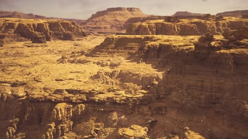 Aerial Flyover Through Arid Desert Canyon