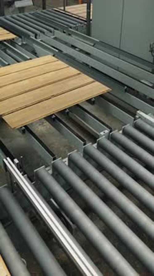 wooden boards are processing at the automated line of plant for the parquet manufacturing.