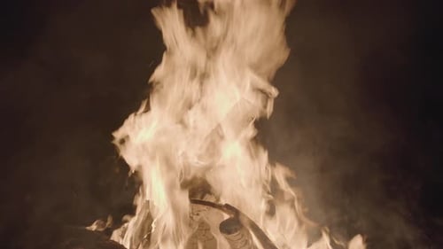 the campfire burned brightly in the night