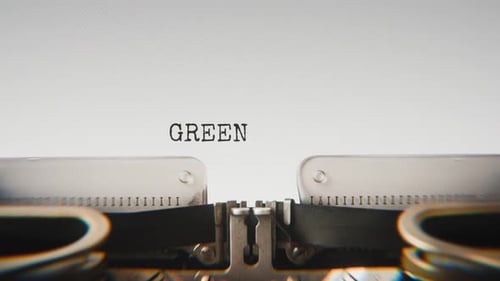 Old mechanical typewriter typing Green Initiative in a close-up view.