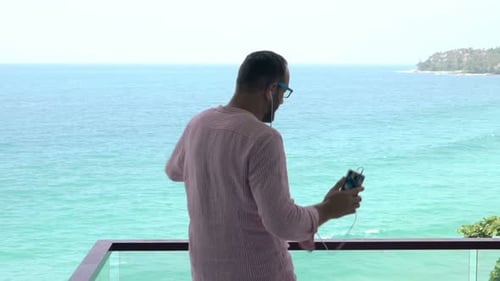 Happy Man Dancing While Listening to Music on Terrace, Super