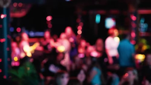 Blurred Crowd Partying in Club at Night