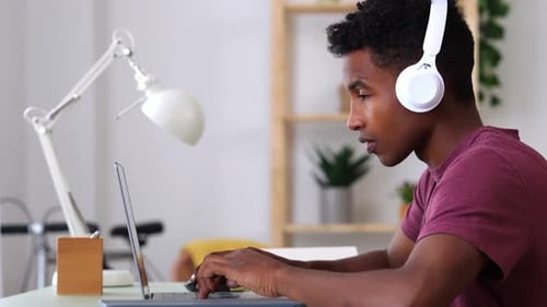 Young Adult Working on Laptop at Home