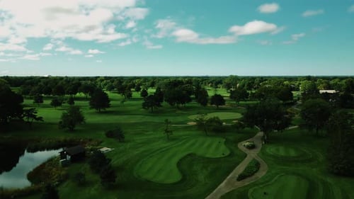 Aerial drone overview of a Golf Club in Northbrook Illinois, USA with white clouds passing by at day