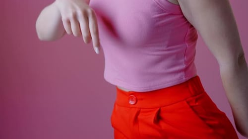 Young Woman Dancing in Pink and Orange Outfit