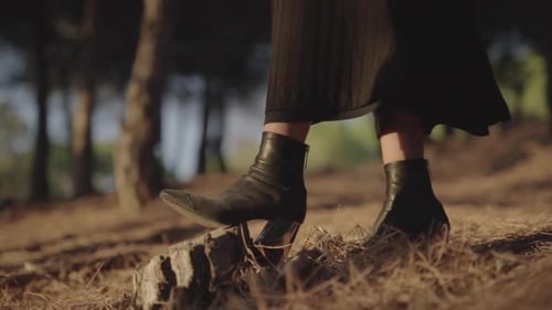 Woman Stepping on Forest Stump Wearing Stylish Boots