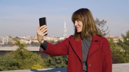 Woman Taking Selfie in Urban Park Setting