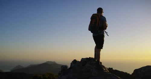 Man, hiking and exercise for adventure, mountain top and peak, climber and backpack
