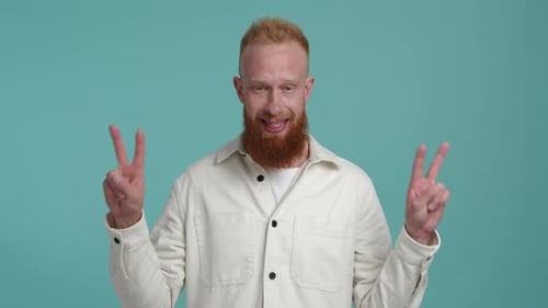 Man Smiles and Holds Up Peace Signs