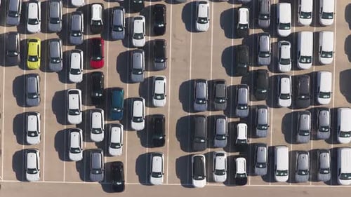 Aerial top down view of new cars parking in a lot