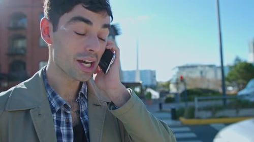 Young Man Speaking on Mobile Phone in the City