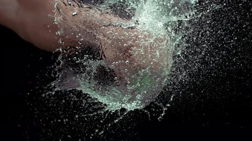 Fist Punches Water Balloon in Slow Motion
