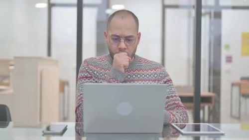 Young Adult Works on Laptop in Modern Office