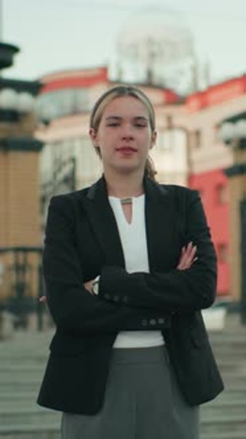 Business Woman Stands Confidently in Front of Building