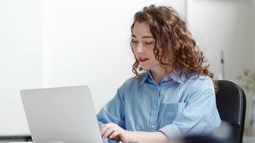 Young Happy Business Woman Employee Sitting at Office Desk Working on Laptop
