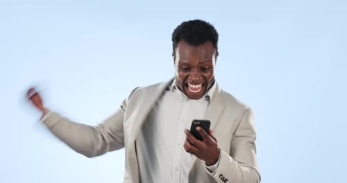 Excited black man, phone and money rain in financial freedom or winning lottery against a studio