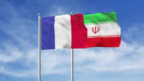 France and Iran Flags Waving Against Blue Sky