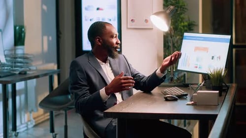 Professional Man Presenting Data at Office Desk
