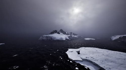 Arctic Ocean Landscape with Icebergs Floating Under Gloomy Sky