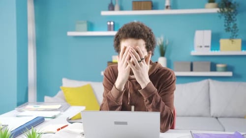 Young Adult Working at Desk in Home Office