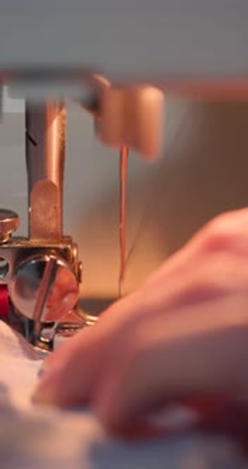 Sewing Machine Needle Working on Cloth Close Up
