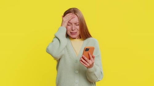 Woman Confused and Upset While Looking at Her Phone
