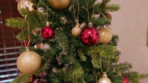 Close-Up of Red and Gold Christmas Tree Decorations in 4K