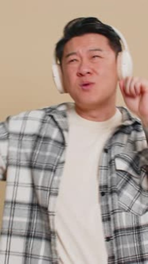 Cheerful Man Listening to Music and Dancing