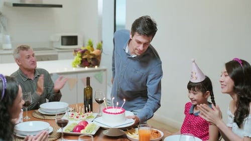 Family Celebrates Birthday with Cake and Cheer