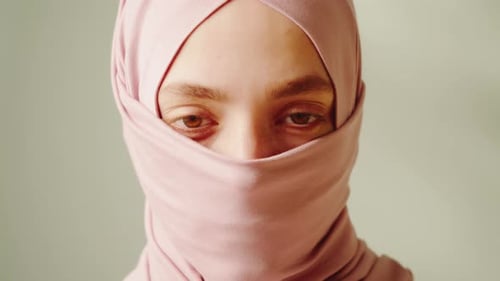 Woman Wearing a Pink Head Covering Close Up