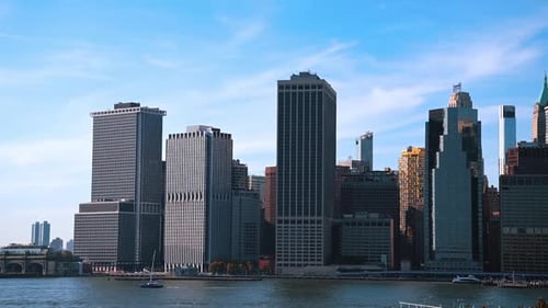 Manhattan high-rises towering above the East River. Architecture of New York from the riverscape.
