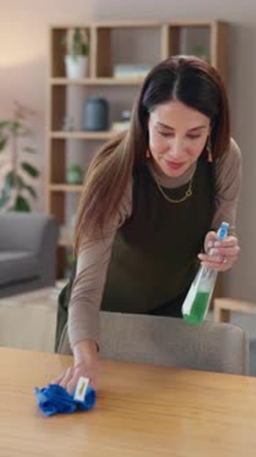 Woman Cleaning a Wooden Table at Home