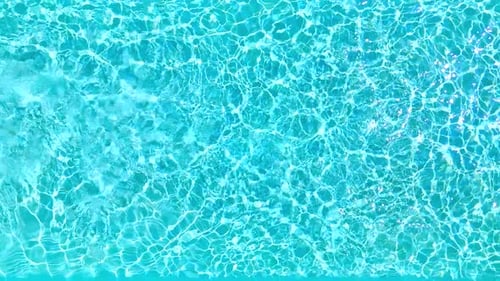 Blue Water in the Swimming Pool with Light Reflections Slow Motion