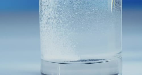 Effervescent Tablet Dissolving in Glass of Water