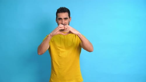 Young Adult Making Heart Shape With Hands