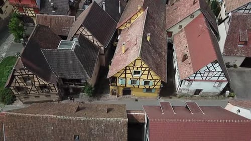 A dolly aerial footage moving to the left alongside a street of the village. The street also has a j