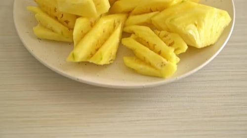 fresh pineapple sliced on plate