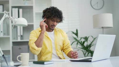 Young Adult Working on Laptop and Video Conferencing